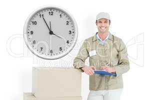 Composite image of happy delivery man writing on clipboard by ca