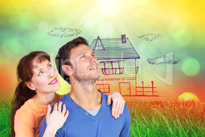 Composite image of happy couple looking upwards