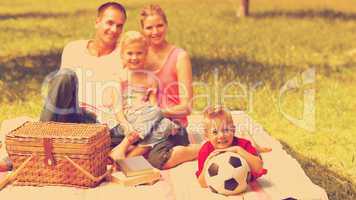 Parents and children relaxing at a picnic