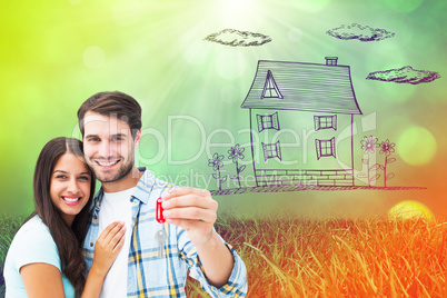 Composite image of happy young couple holding new house key