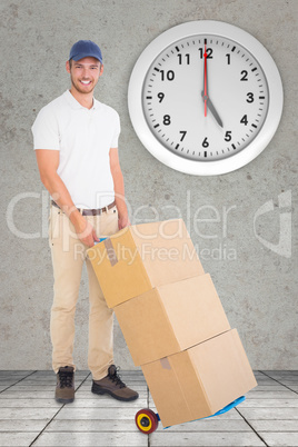 Composite image of happy delivery man pushing trolley of boxes