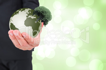 Composite image of businessman holding out his hand