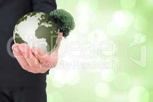 Composite image of businessman holding out his hand