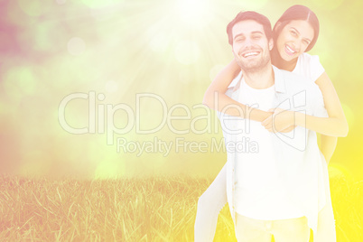 Composite image of happy casual man giving pretty girlfriend pig