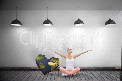 Composite image of woman sitting with arms raised