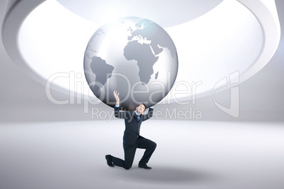 Composite image of businessman carrying the world