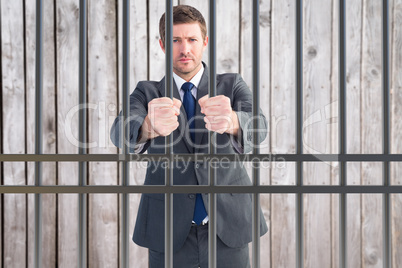 Composite image of businessman holding his hands out