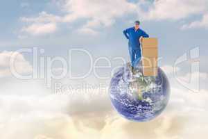 Composite image of happy delivery man leaning on pile of cardboa