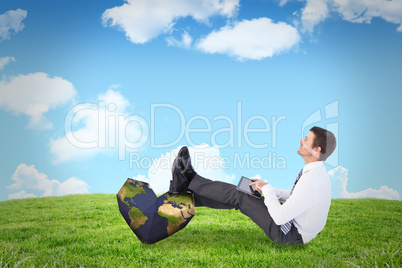 Composite image of businessman using tablet