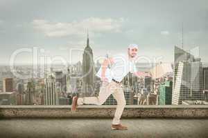 Composite image of delivery man with cardboard boxes running