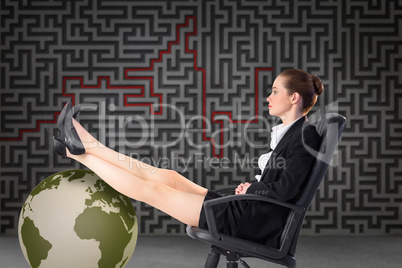 Composite image of businesswoman sitting on swivel chair with fe