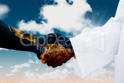 Composite image of closeup of a doctor and patient shaking hands