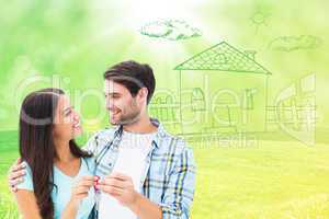 Composite image of happy young couple holding new house key