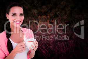 Composite image of pretty brunette holding a mug