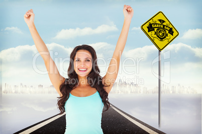 Composite image of casual brunette cheering at camera