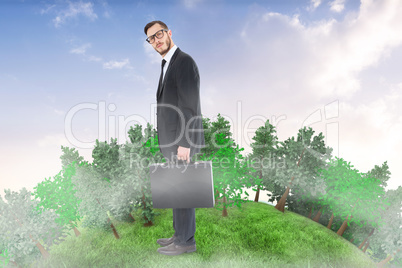 Composite image of geeky businessman holding his briefcase