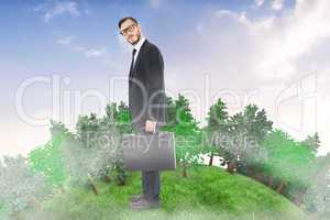 Composite image of geeky businessman holding his briefcase