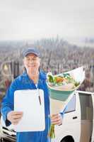 Composite image of happy flower delivery man showing clipboard