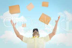 Composite image of delivery man with arms raised