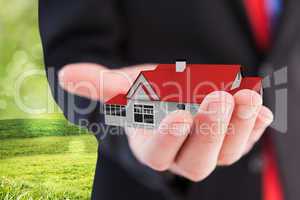 Composite image of businessman presenting with his hand