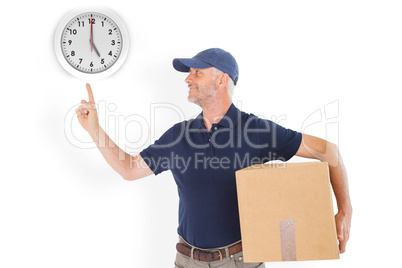 Composite image of happy delivery man holding cardboard box and