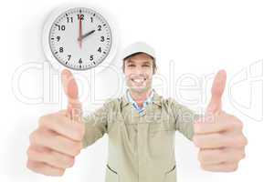 Composite image of happy delivery man showing thumbs up