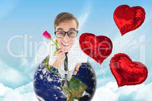Composite image of geeky hipster holding a red rose