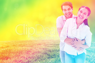 Composite image of cute couple hugging and smiling at camera