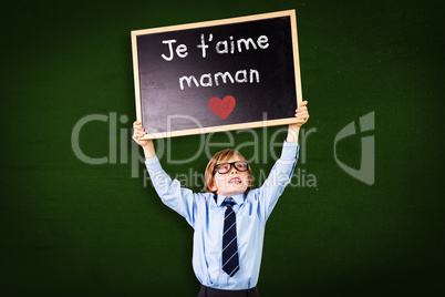Composite image of cute pupil holding chalkboard