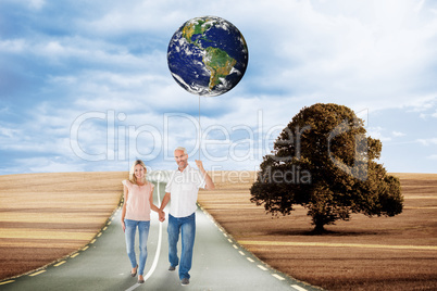 Composite image of happy couple walking holding hands