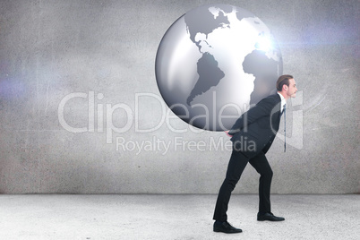 Composite image of businessman carrying the world