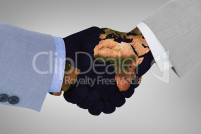 Composite image of close up side view of shaking hands