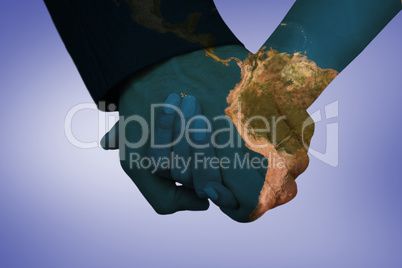 Composite image of newlyweds holding hands close up