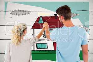 Composite image of young couple painting with roller