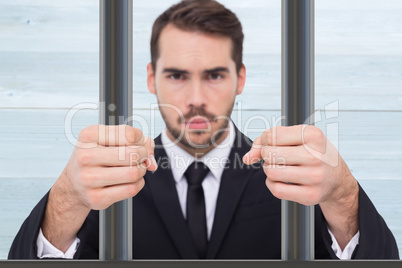 Composite image of exasperated businessman with clenched fists