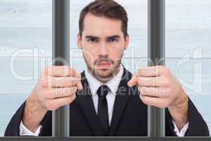 Composite image of exasperated businessman with clenched fists