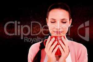 Composite image of pretty brunette holding a mug