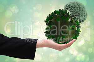 Composite image of businesswomans hand presenting