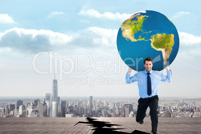 Composite image of businessman carrying the world