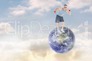 Composite image of geeky hipster posing in sportswear