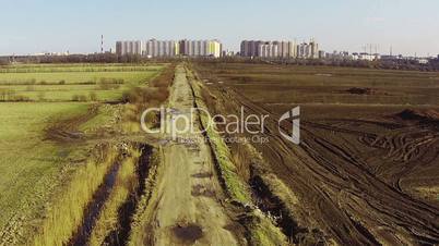 Flying Above Road Between Agricultural Fields, aerial view