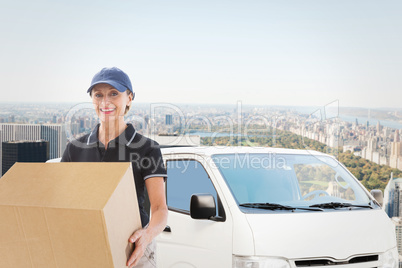 Composite image of happy delivery woman holding cardboard box