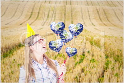 Composite image of geeky hipster holding red balloons