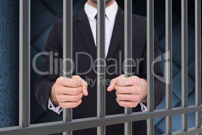 Composite image of elegant businessman in suit clenching his fis