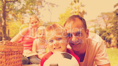 Smiling family relaxing at a picnic