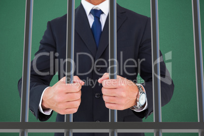 Composite image of portrait of a businessman clenching fists