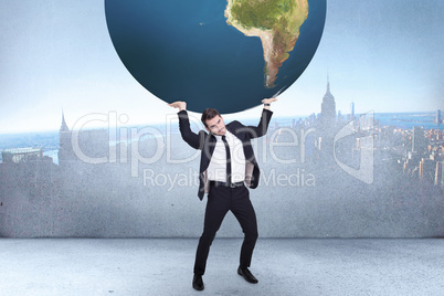 Composite image of businessman carrying the world