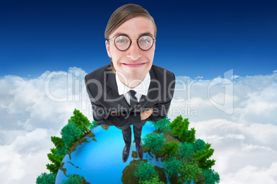 Composite image of geeky businessman smiling at camera