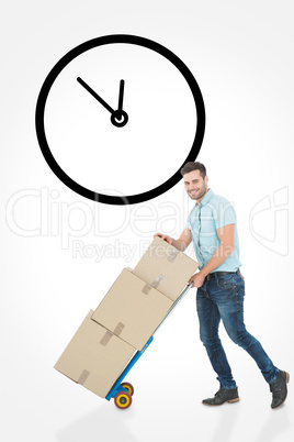 Composite image of happy delivery man pushing trolley of boxes