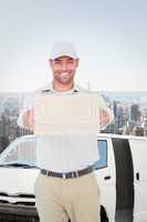 Composite image of portrait of happy delivery man giving package